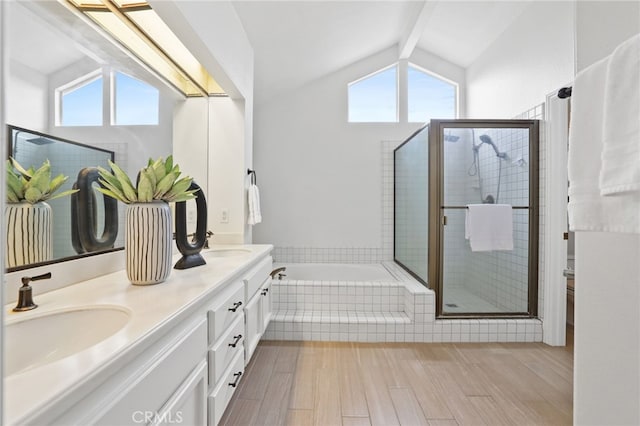 full bathroom featuring lofted ceiling with beams, a shower stall, a sink, and a healthy amount of sunlight