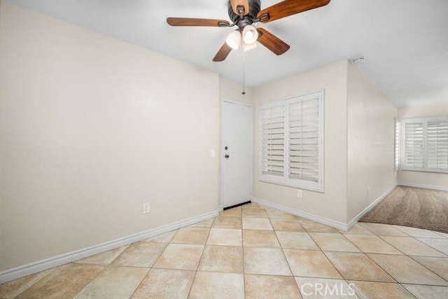 unfurnished room featuring ceiling fan and light tile patterned flooring