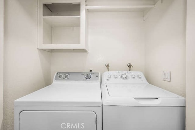 clothes washing area with washer and dryer