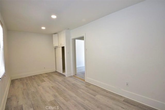 unfurnished room with light hardwood / wood-style floors