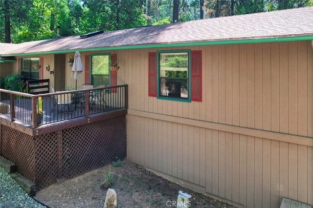 view of side of home featuring a wooden deck