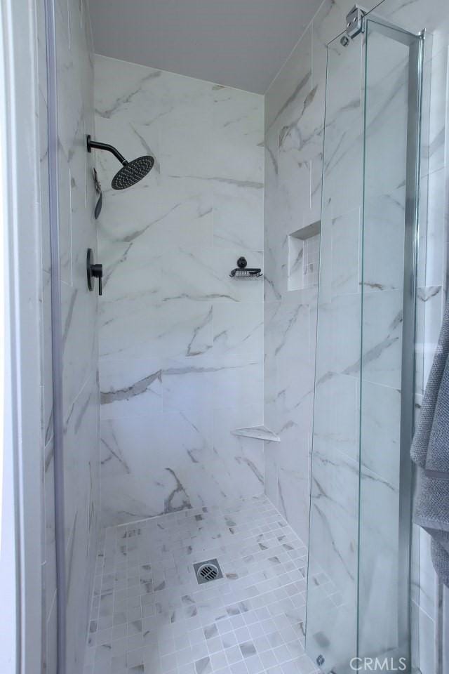 bathroom with a tile shower