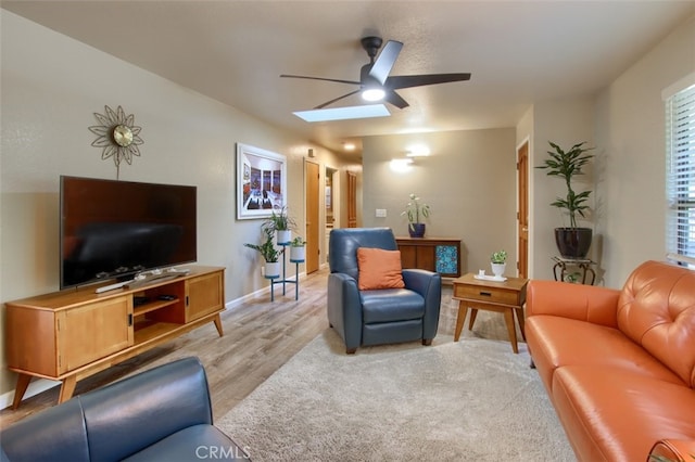 living room with light wood-type flooring and ceiling fan