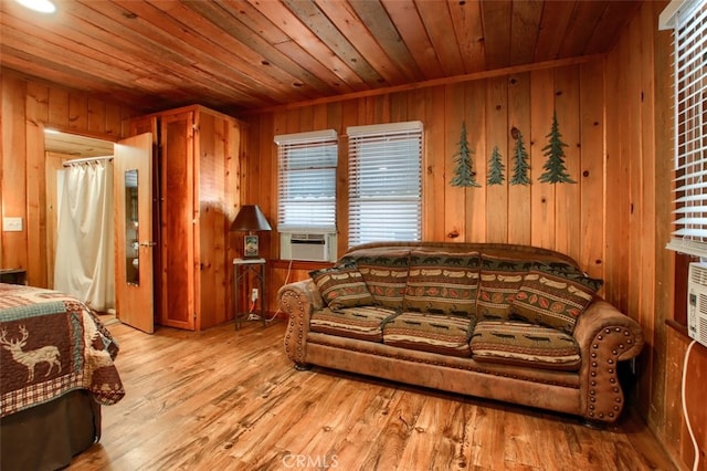 living room with wood ceiling, wooden walls, cooling unit, and light hardwood / wood-style floors