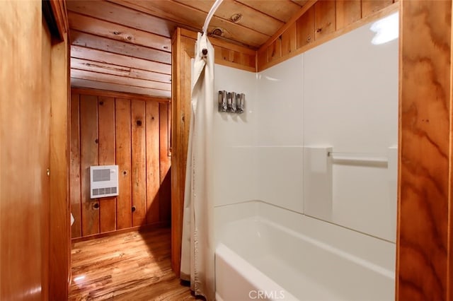 bathroom featuring heating unit, wooden walls, wood-type flooring, and wooden ceiling