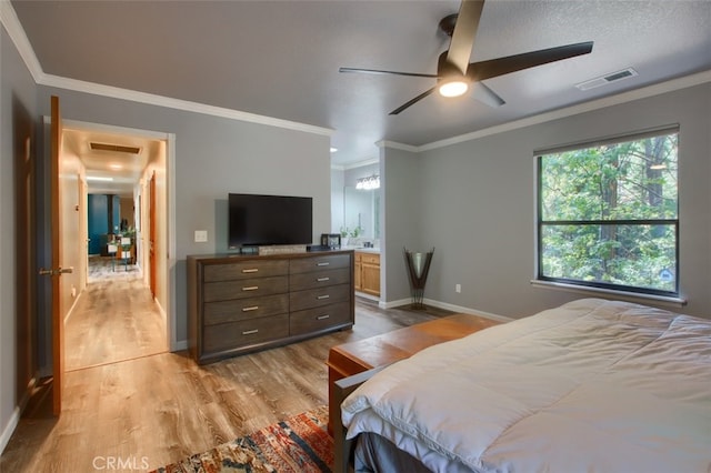 bedroom featuring ensuite bathroom, a textured ceiling, ceiling fan, crown molding, and light hardwood / wood-style floors