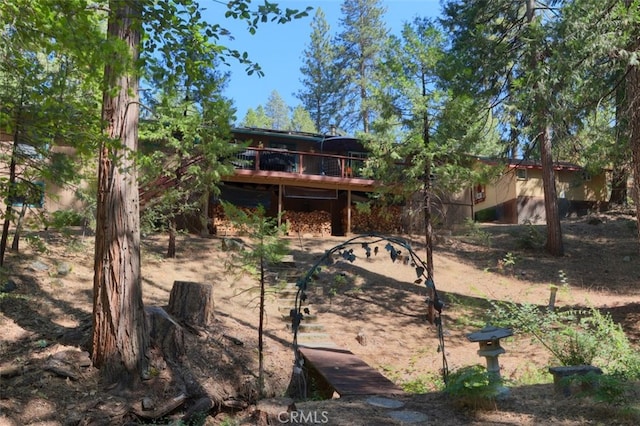 rear view of house with a wooden deck