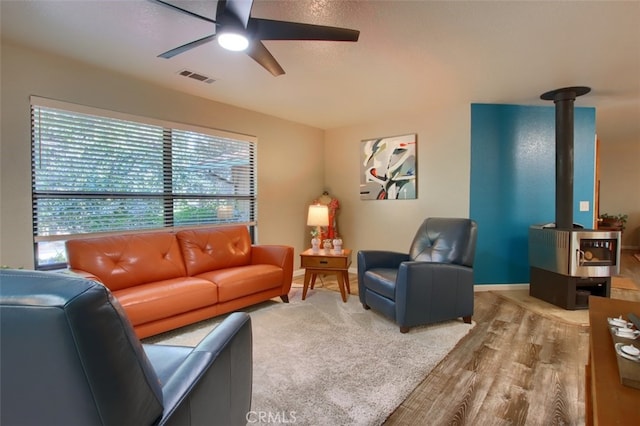 living room featuring hardwood / wood-style flooring and ceiling fan