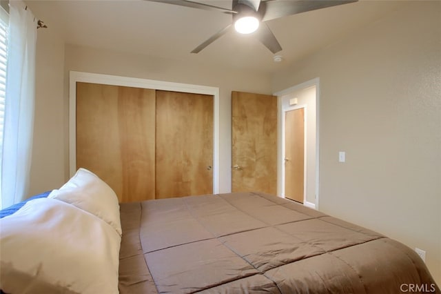 bedroom featuring ceiling fan and a closet