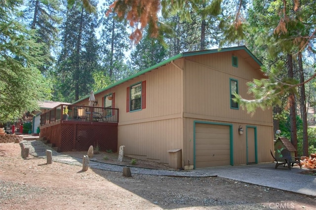 36555 Mudge Ranch Rd, Coarsegold, CA 93614 - view of front of house featuring driveway, a wooden deck, and an attached garage