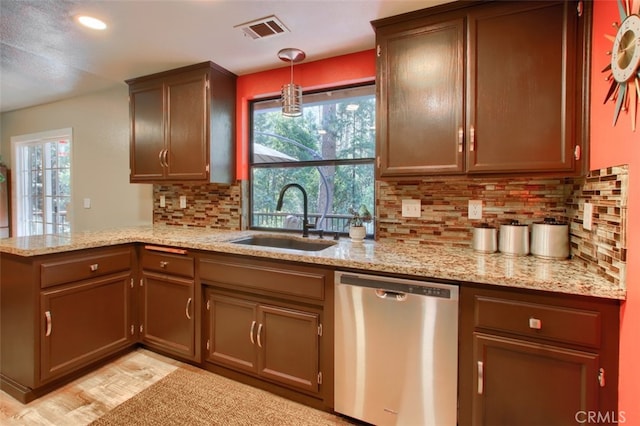 36555 Mudge Ranch Rd, Coarsegold, CA 93614 - kitchen with dishwasher, a peninsula, decorative backsplash, hanging light fixtures, and light stone counters
