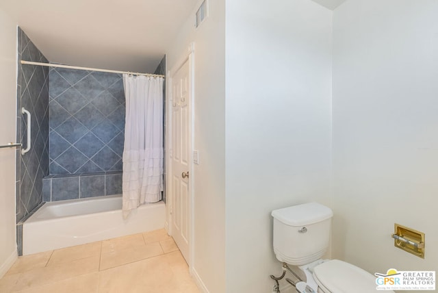 bathroom with tile patterned floors, shower / bath combination with curtain, and toilet