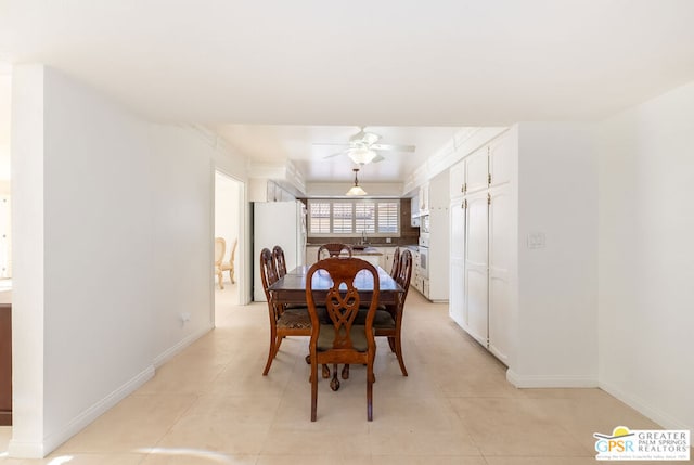 dining space featuring light tile patterned floors, ceiling fan, and sink