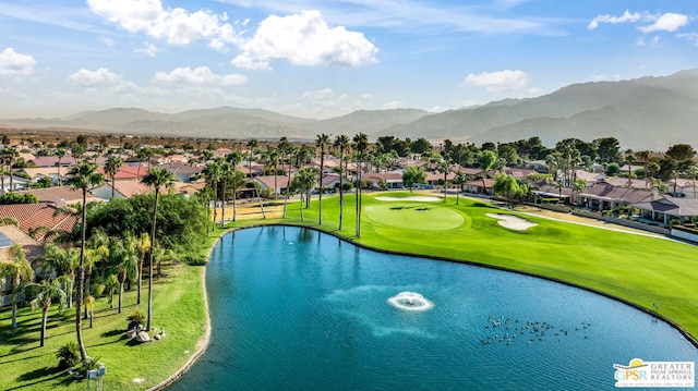 exterior space with a lawn and a water and mountain view