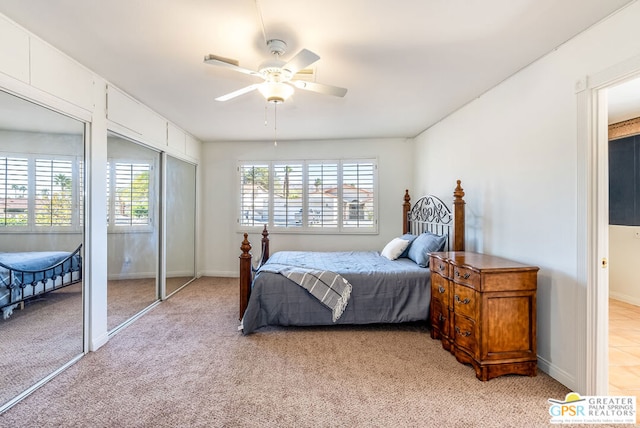 carpeted bedroom with ceiling fan and multiple windows