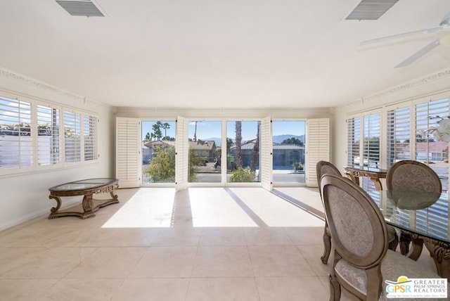 sunroom featuring ceiling fan