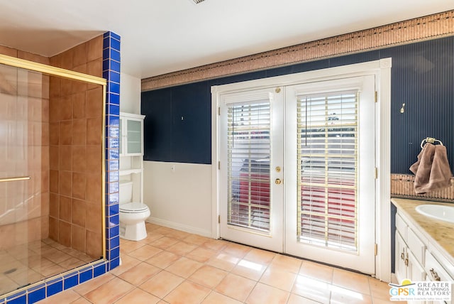 bathroom featuring tile patterned floors, toilet, french doors, and walk in shower