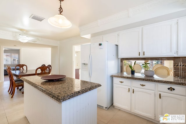 kitchen with white cabinetry, ceiling fan, hanging light fixtures, and white refrigerator with ice dispenser