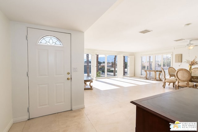 entrance foyer with light tile patterned floors and ceiling fan