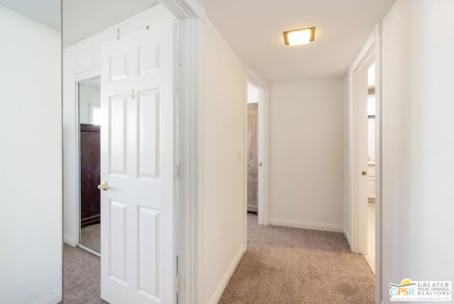 corridor featuring light colored carpet