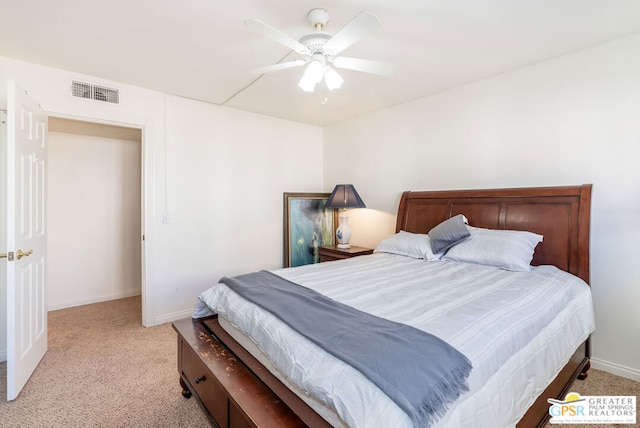 bedroom with ceiling fan and light carpet