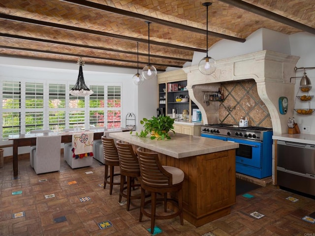 kitchen with brick ceiling, pendant lighting, lofted ceiling with beams, a center island, and range with gas stovetop