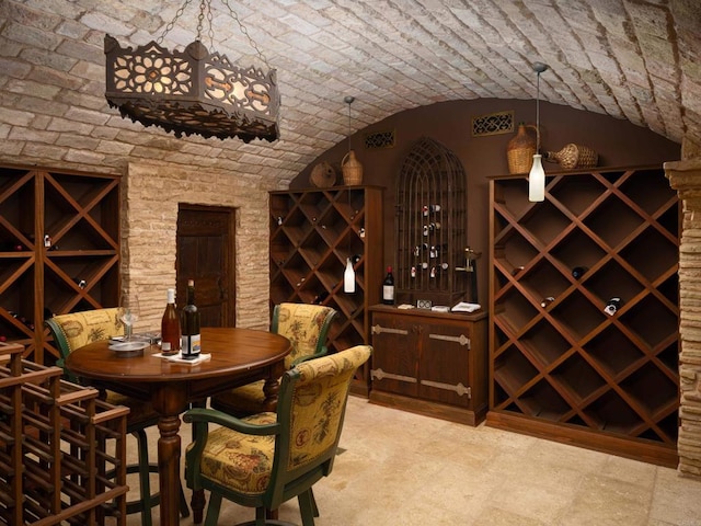 wine room with brick ceiling and vaulted ceiling