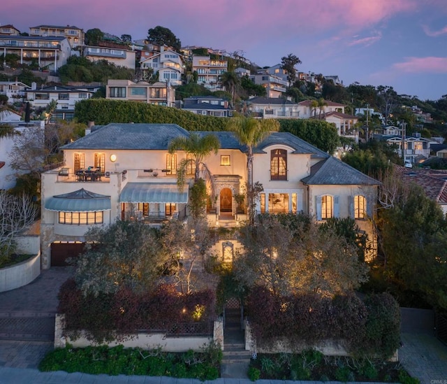 mediterranean / spanish-style home with a residential view and stucco siding