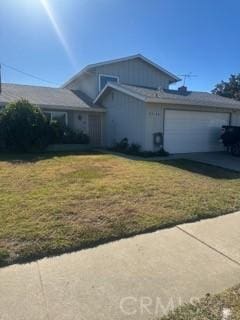 view of front of property with a front yard and a garage