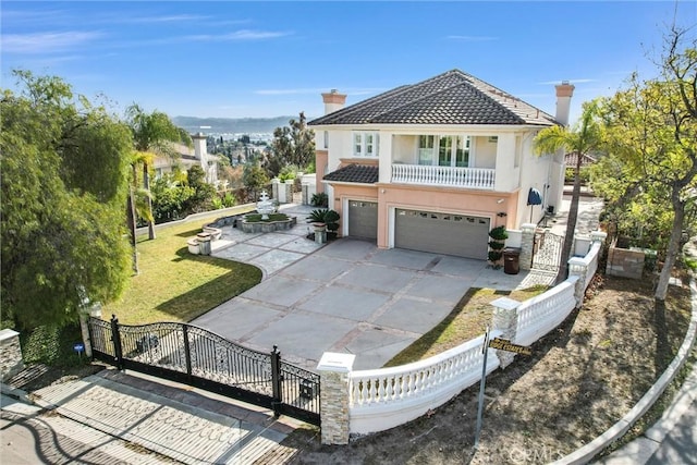 mediterranean / spanish house with a front yard and a garage