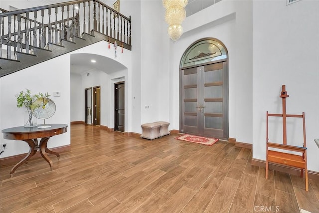 foyer with french doors and a towering ceiling