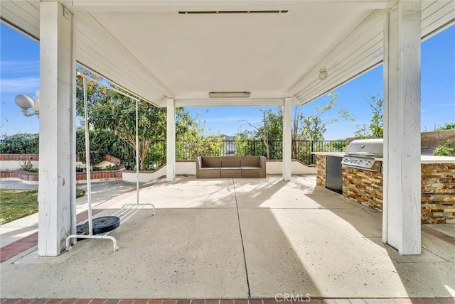 view of patio featuring an outdoor kitchen and a grill