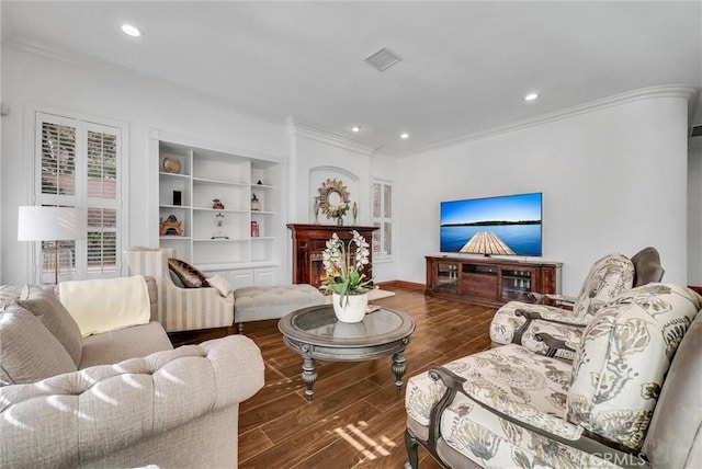 living room featuring built in features and ornamental molding