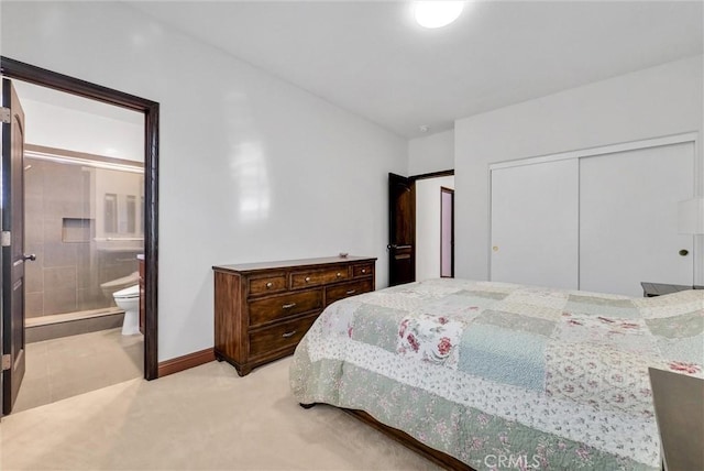 carpeted bedroom featuring ensuite bath and a closet