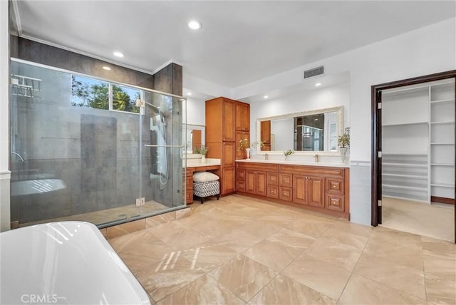 bathroom featuring vanity and independent shower and bath