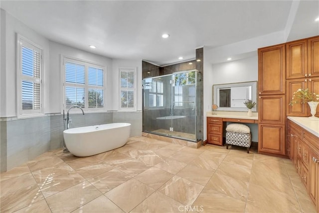 bathroom featuring shower with separate bathtub and vanity