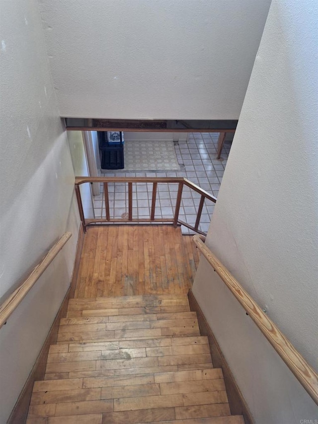 stairway featuring hardwood / wood-style flooring