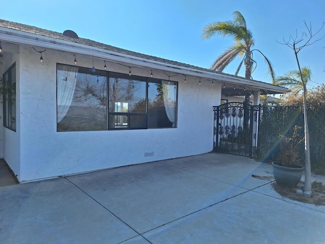 view of property exterior with a patio area