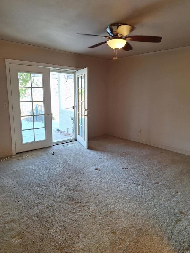 carpeted empty room featuring ceiling fan