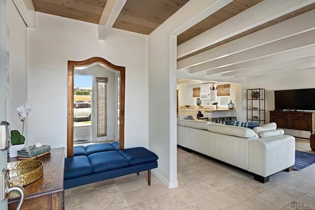 living room with wooden ceiling, a chandelier, and beamed ceiling