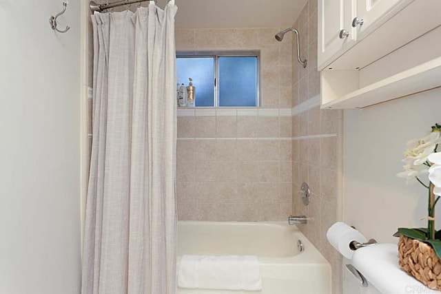 bathroom featuring toilet and shower / tub combo with curtain