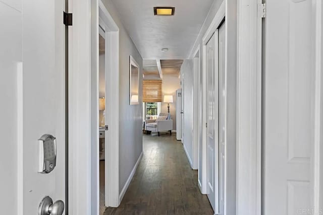 corridor with dark hardwood / wood-style flooring