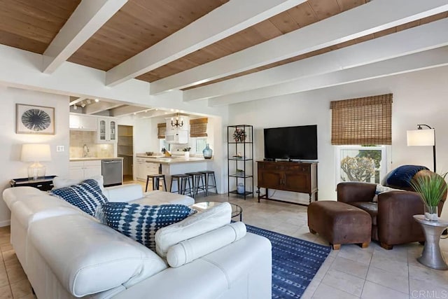 tiled living room featuring sink, a chandelier, wood ceiling, and beamed ceiling