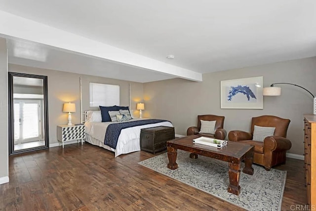 bedroom with dark wood-type flooring and beam ceiling