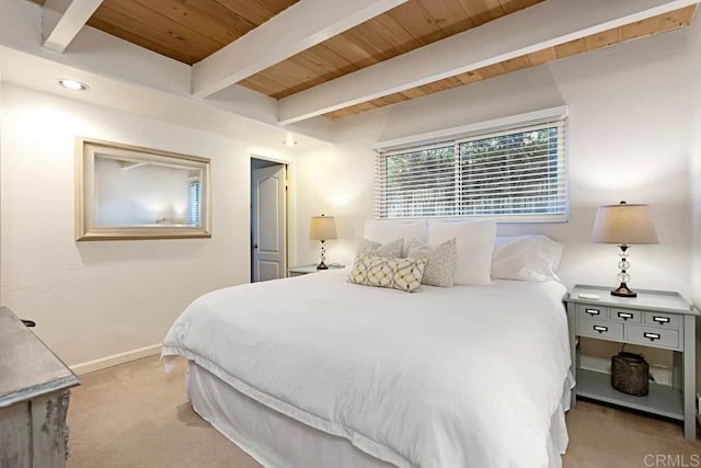 carpeted bedroom featuring beam ceiling and wooden ceiling