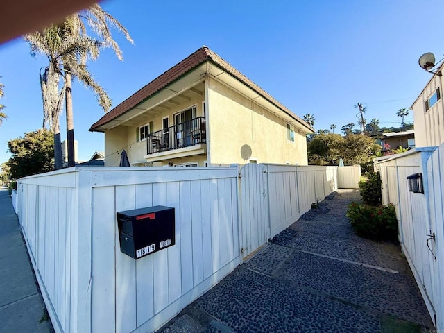 view of side of home featuring a balcony