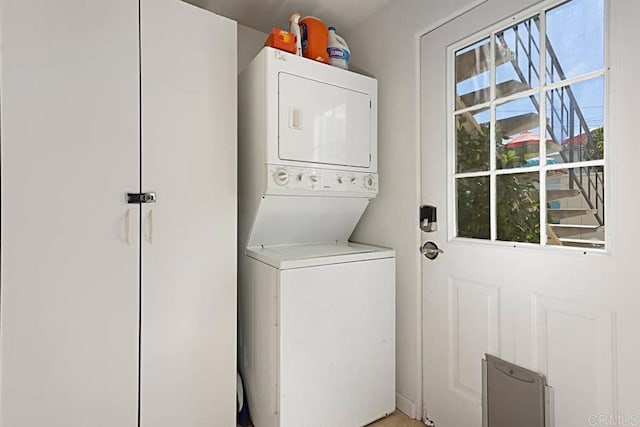 laundry room with stacked washer / dryer