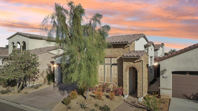 mediterranean / spanish house with a garage