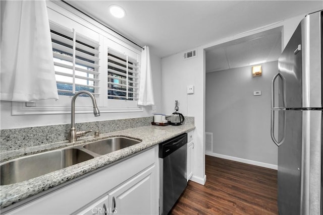 kitchen featuring light stone counters, sink, white cabinets, and appliances with stainless steel finishes