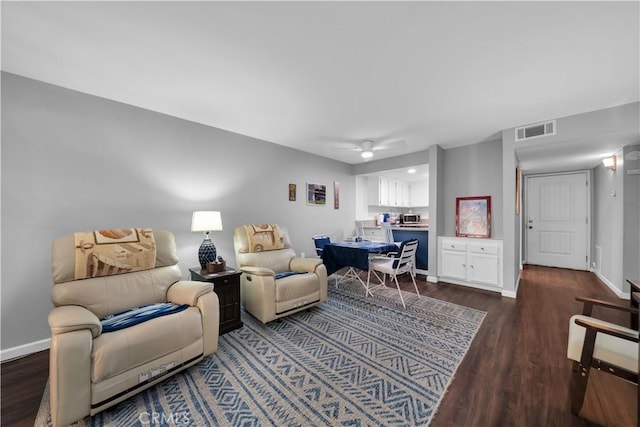 living room with ceiling fan and dark hardwood / wood-style flooring